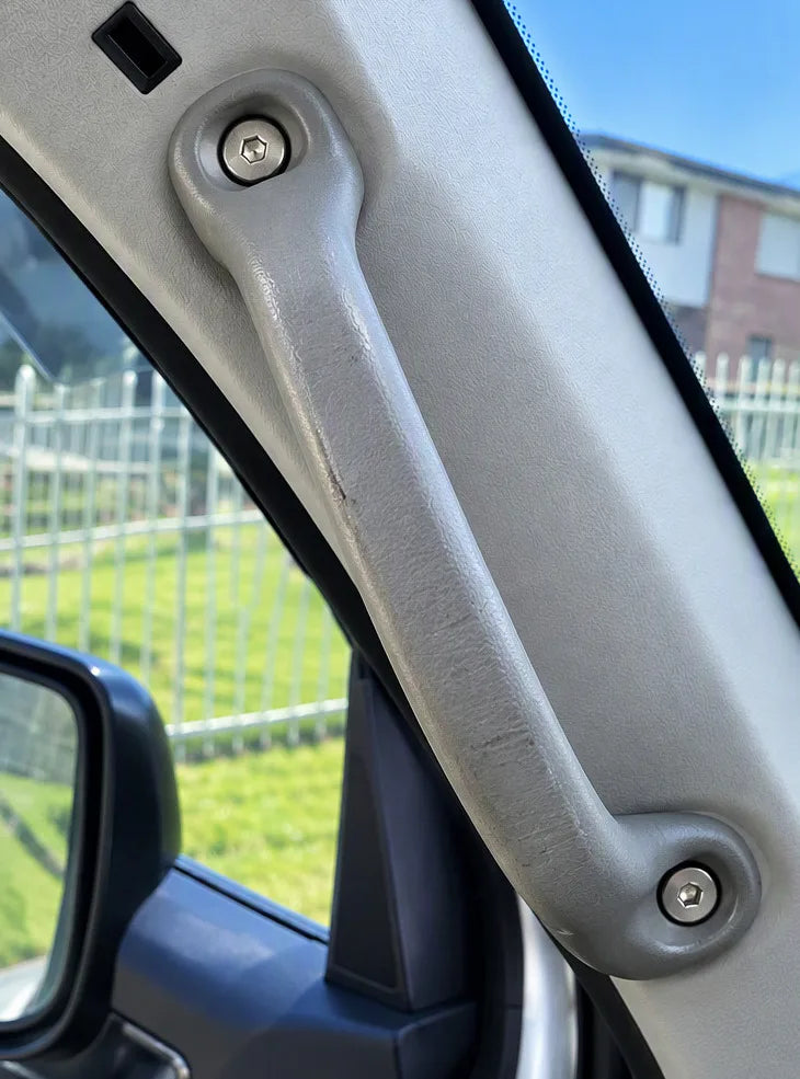 Factory plastic grab handle on a vehicle pillar
