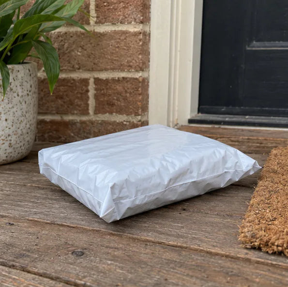 A padded Krawlergrips parcel waiting on a timber doorstep